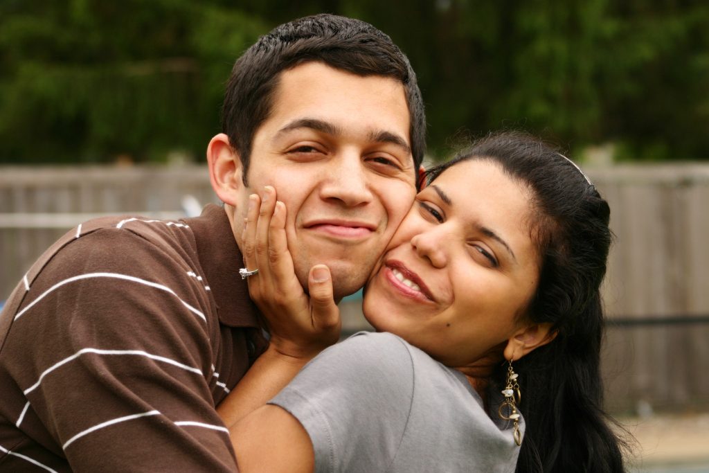 Happy Hispanic Couple Hugging - Family Service Agency